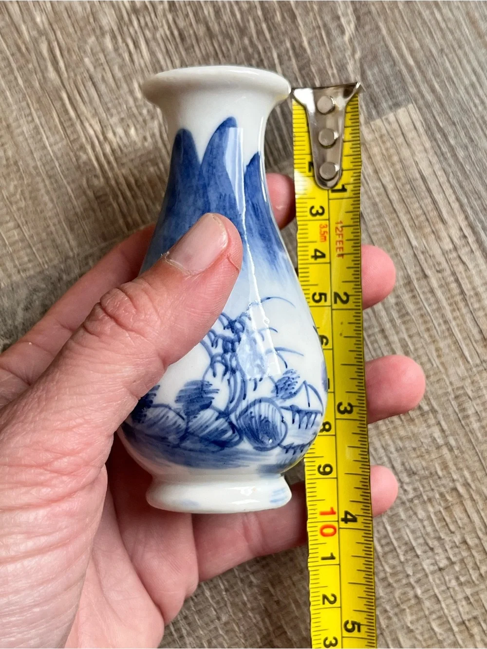 Chinese style porcelain bud vase with a flared rim and hand-painted landscape